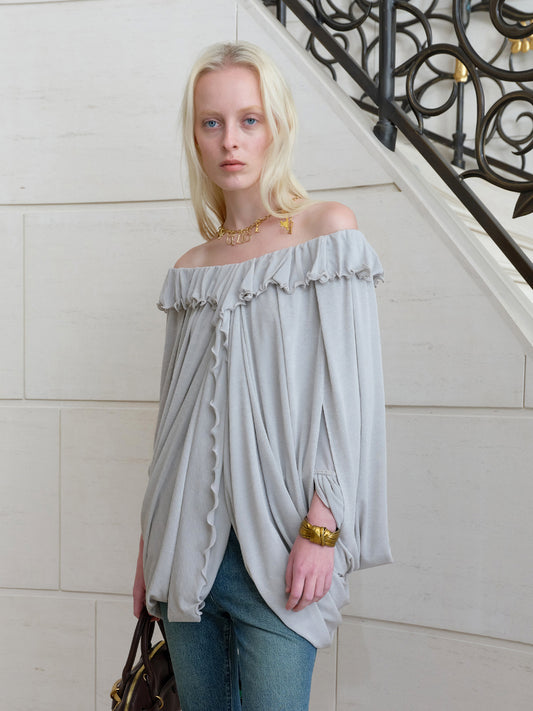 Ruffled cape-draped top
